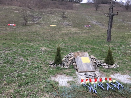 Memorial Cairn, Flags, Roses and Candles.